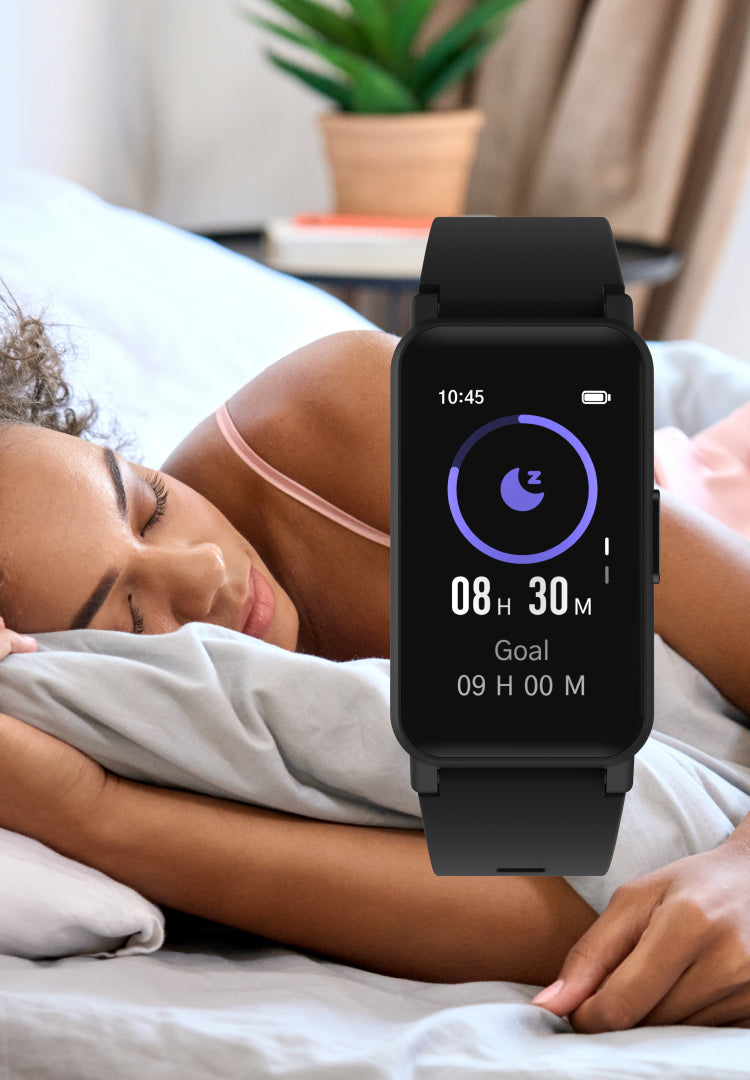 Person lying in bed with a smartwatch displaying sleep tracking information.