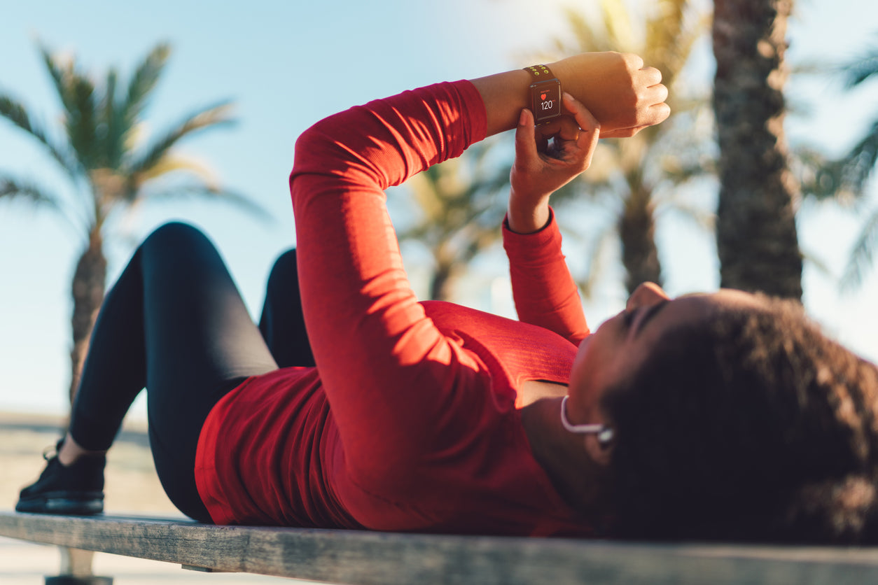 woman using her smartwatch to track her workout