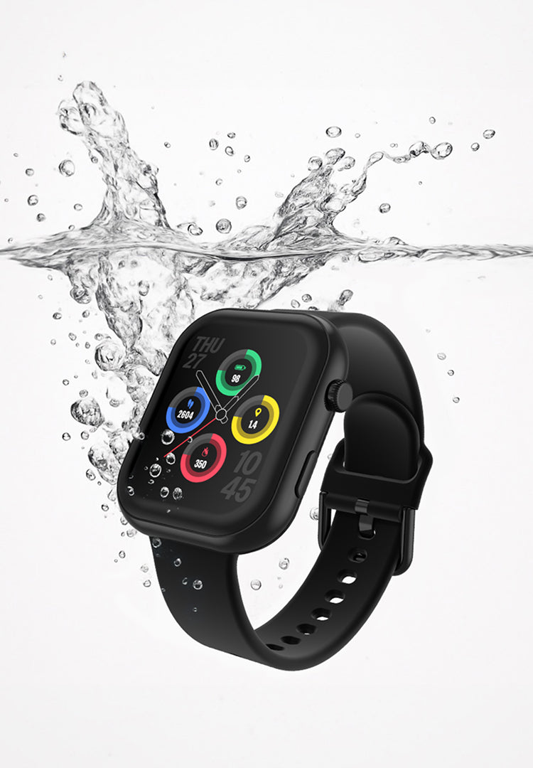 Black smartwatch with colorful display splashing in water